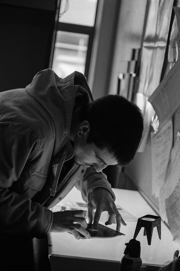 Student preparing negative for enlarger.