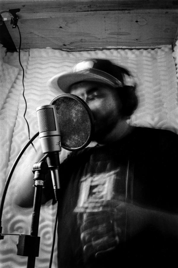 A rapper in a vocal booth.