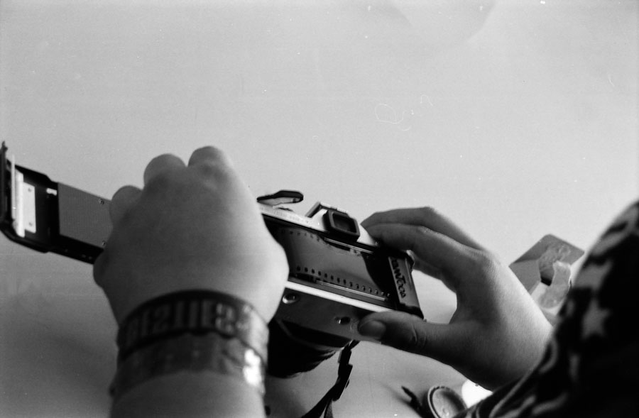 Student loading new roll of film into camera.